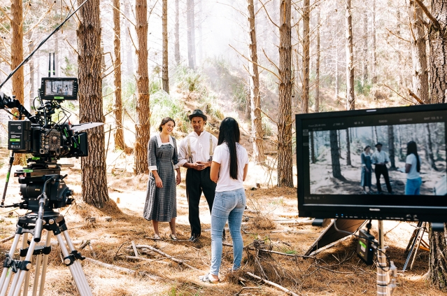 Director talking to actors behind the scenes on film set